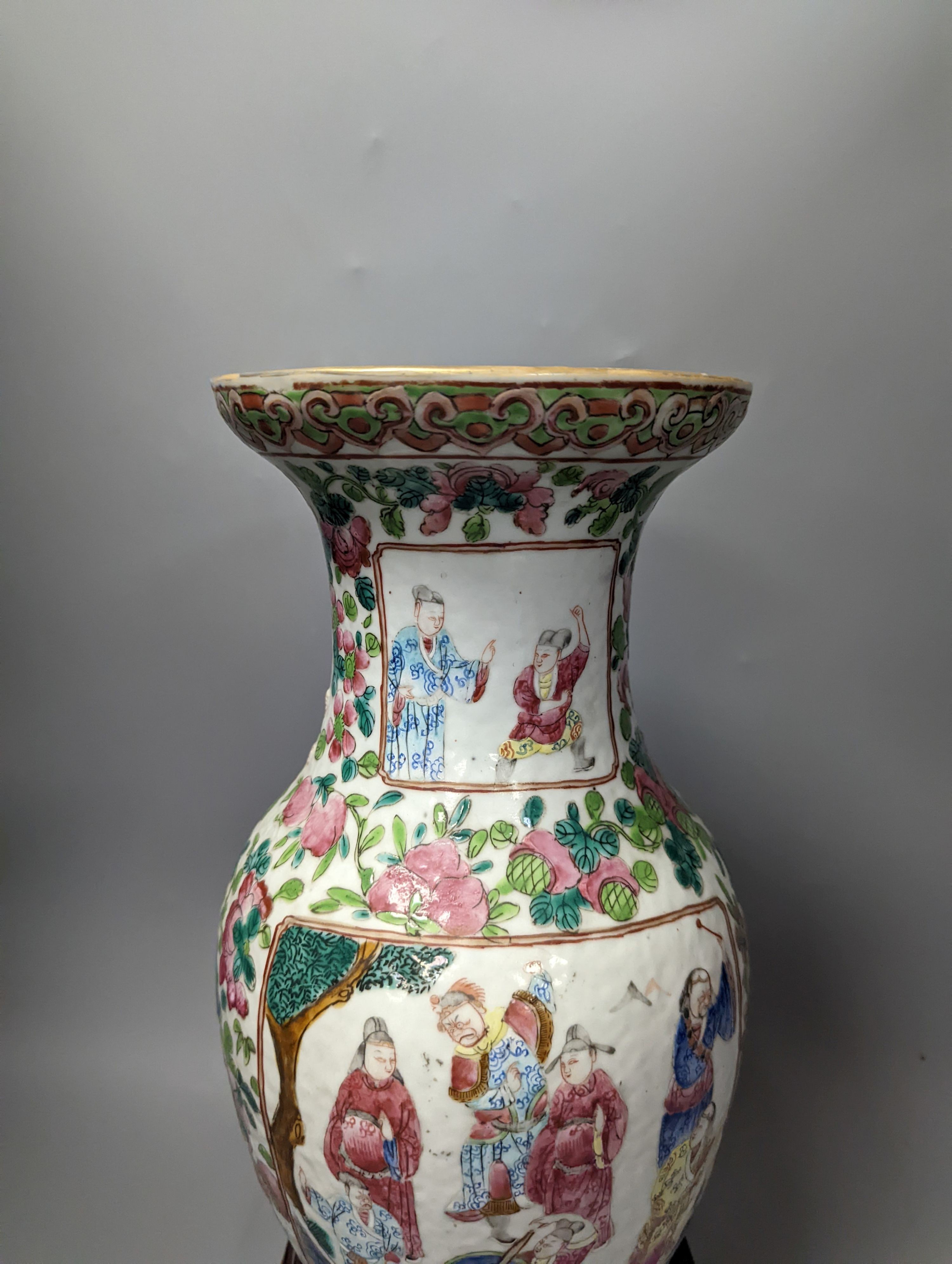 A 19th century Chinese famille rose vase on wooden stand, 37 cms high including stand.